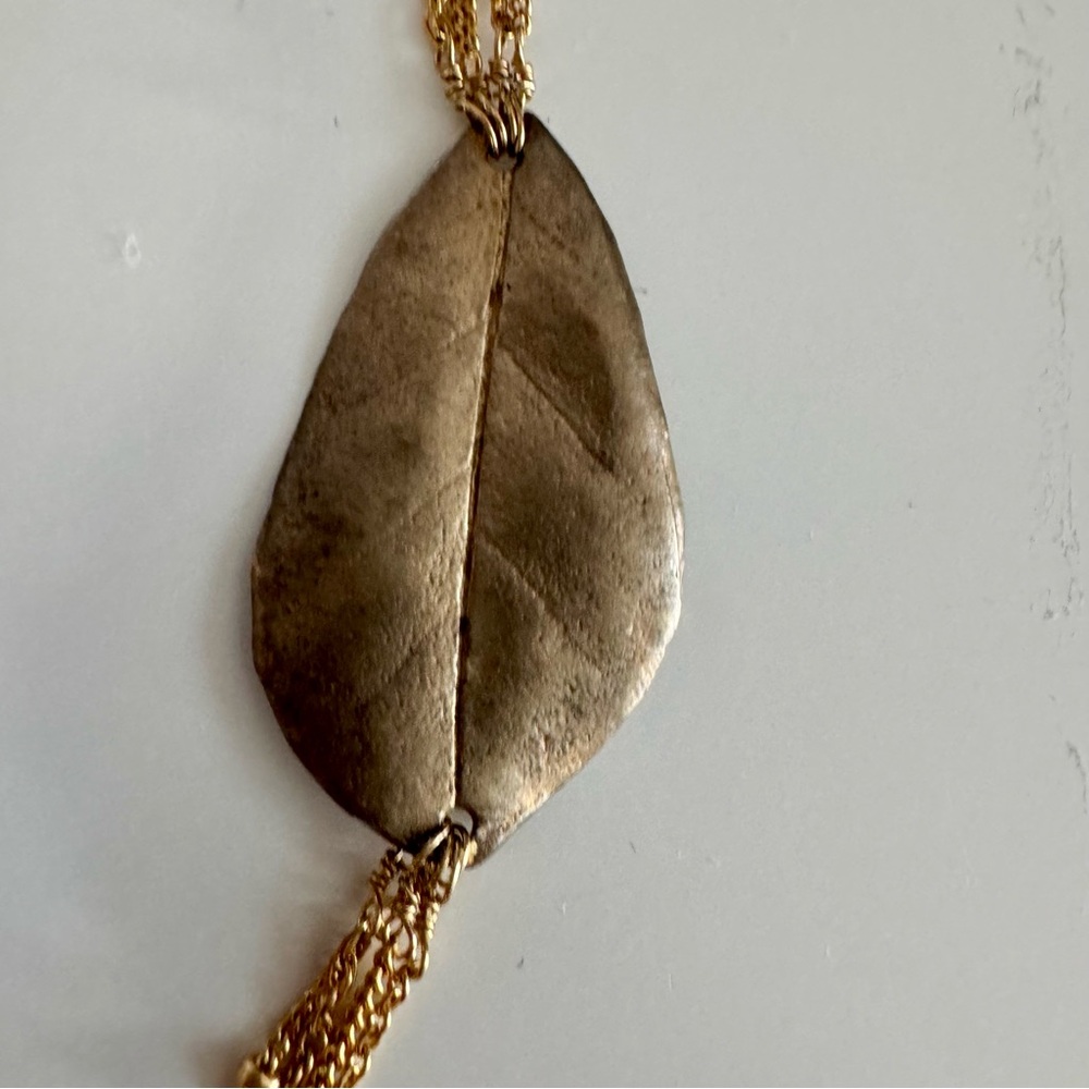 NWOT Four Strand Gold Tone Necklace with Asymmetric Leaf